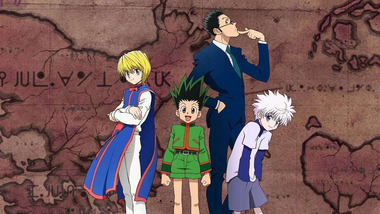 Yoshihiro Togashi sentado em cadeira ergonômica, segurando garrafa de água e usando pulseira de frequência cardíaca