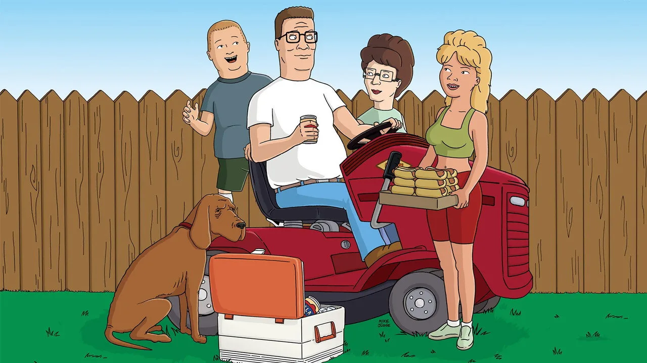 Hank Hill, de terno de gerente, segura halteres ao lado de um cilindro de propano em um ginásio