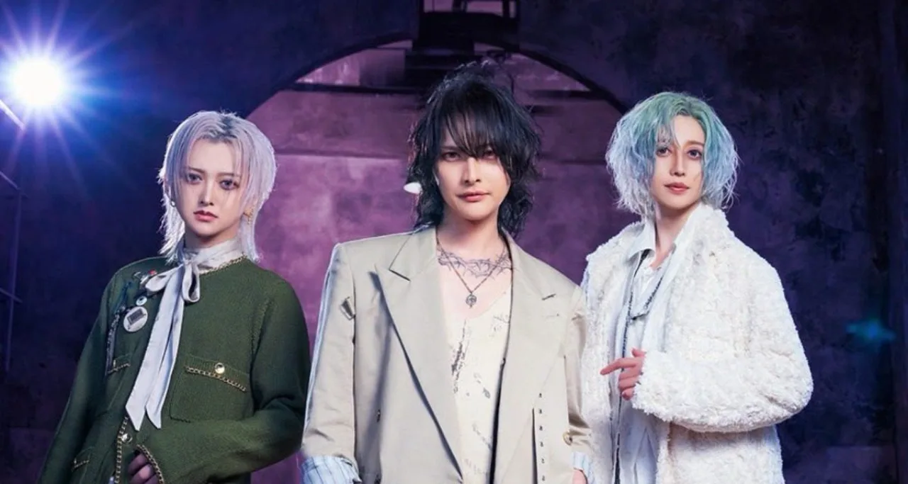 Trio visual kei VALHALLA posa ao lado da capa do álbum de estreia DOMINION, com estética sombria e logo da banda
