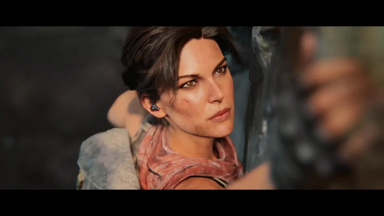 Jovem vestindo roupa de treino, segurando halteres, com um joystick ao lado e um pôster de Lara Croft ao fundo