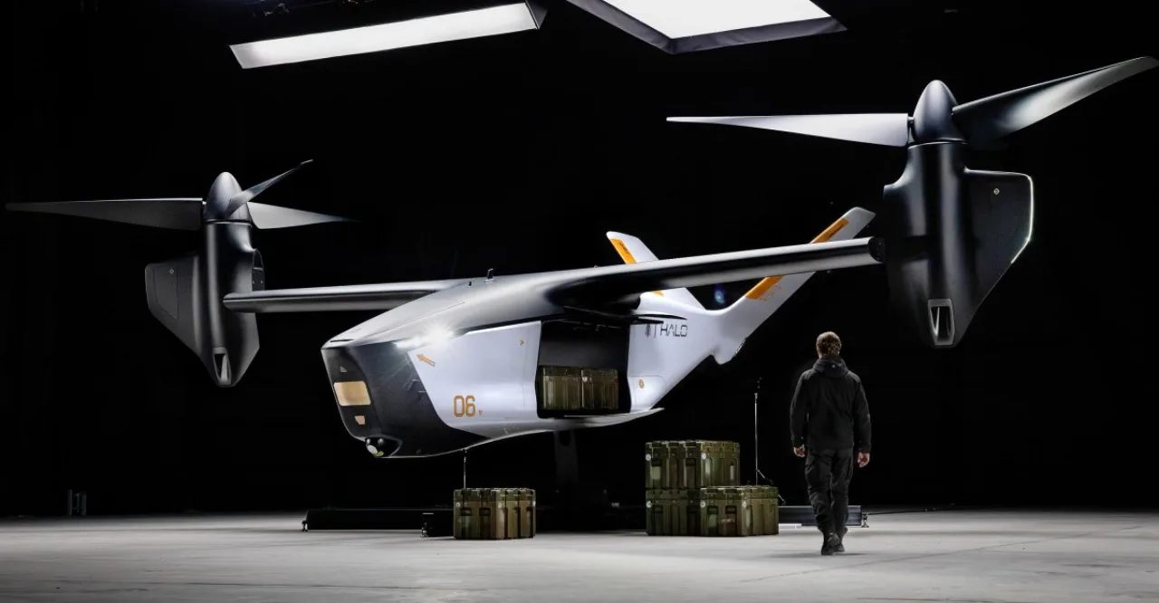 Um atleta em roupa esportiva faz agachamento ao lado de um drone VTOL elétrico em voo estacionário