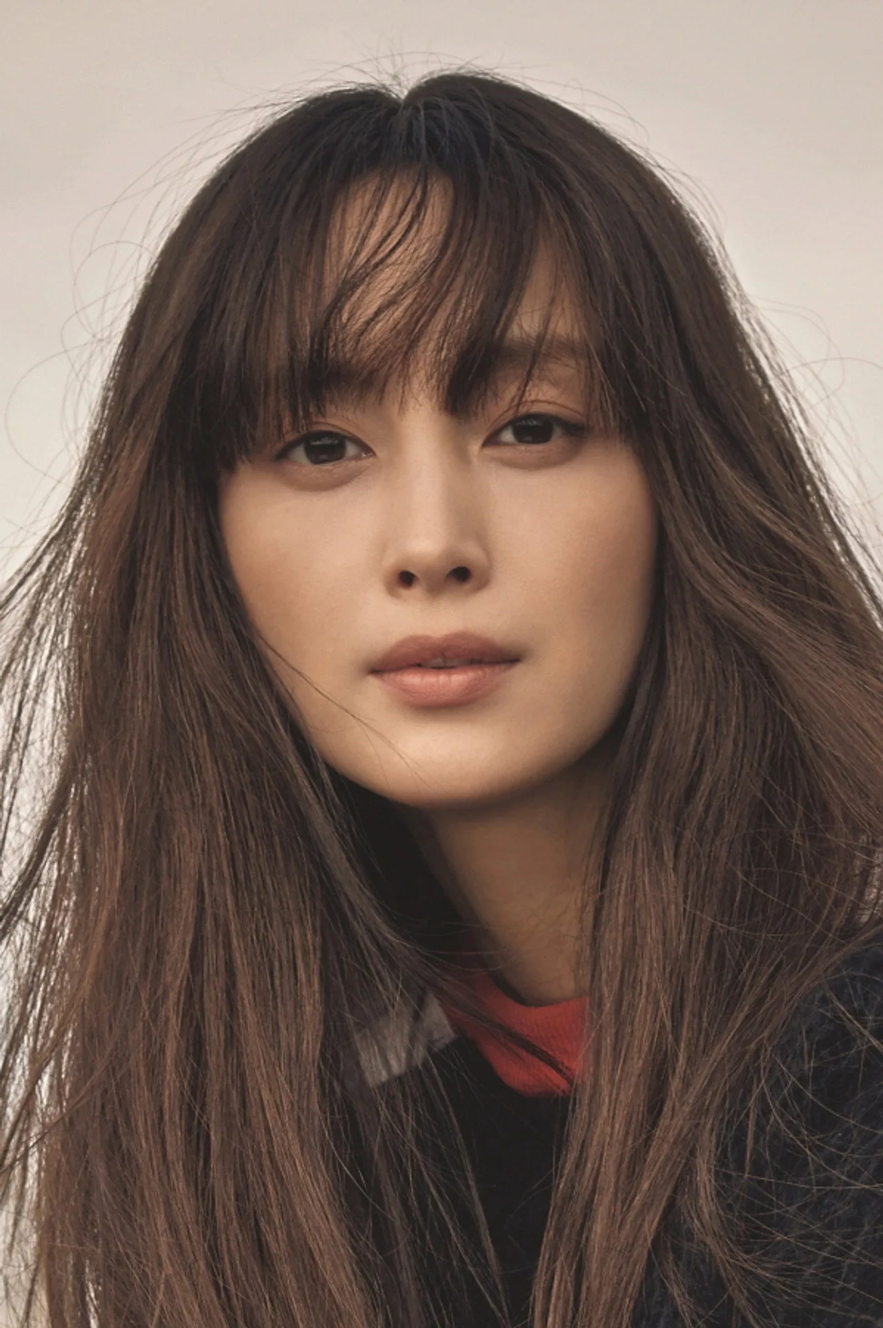 Lee Na Young faz alongamento em tapete de yoga, usando roupa esportiva cinza e segurando uma garrafa d'água