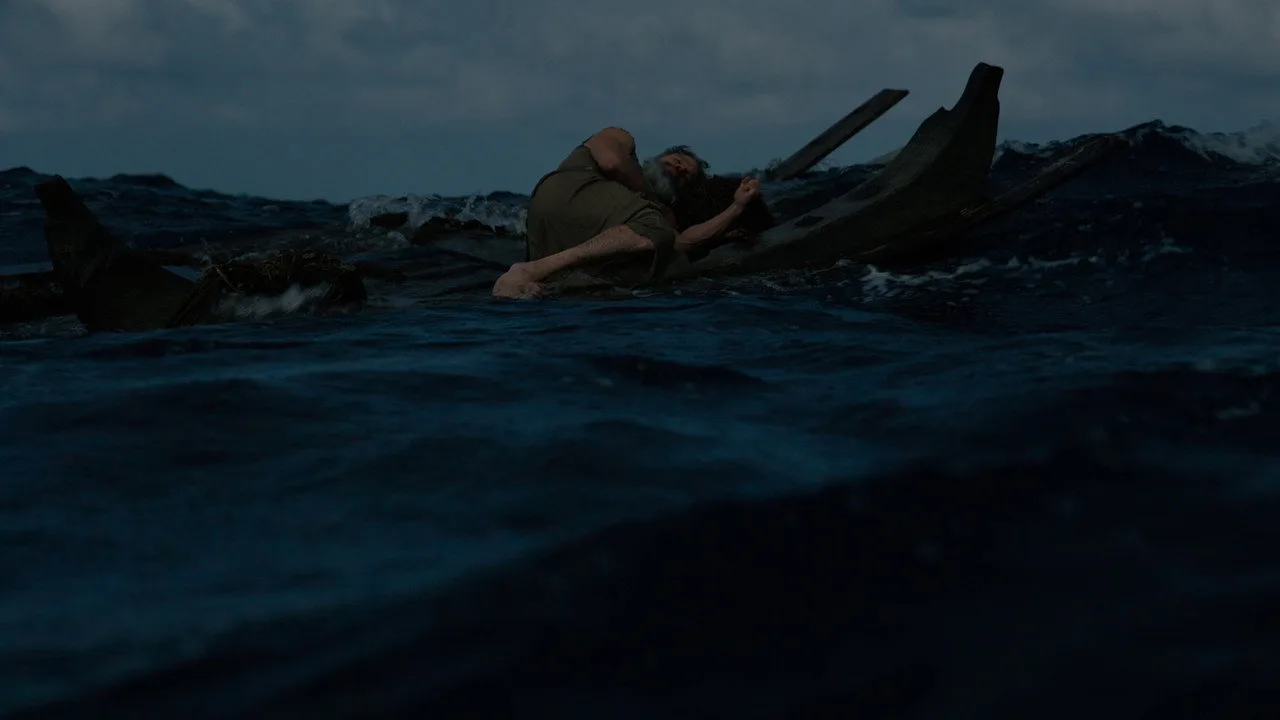 Atleta em esteira segurando um balde de pipoca ao lado de cartaz de The Odyssey