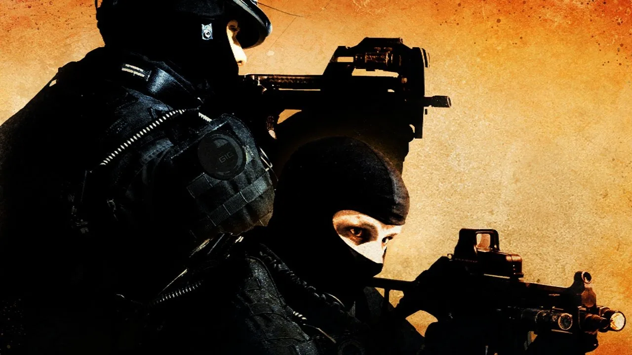 Jogador de e‑sports faz alongamento de punhos ao lado de teclado, mouse, garrafa de água e monitor exibindo CS:GO