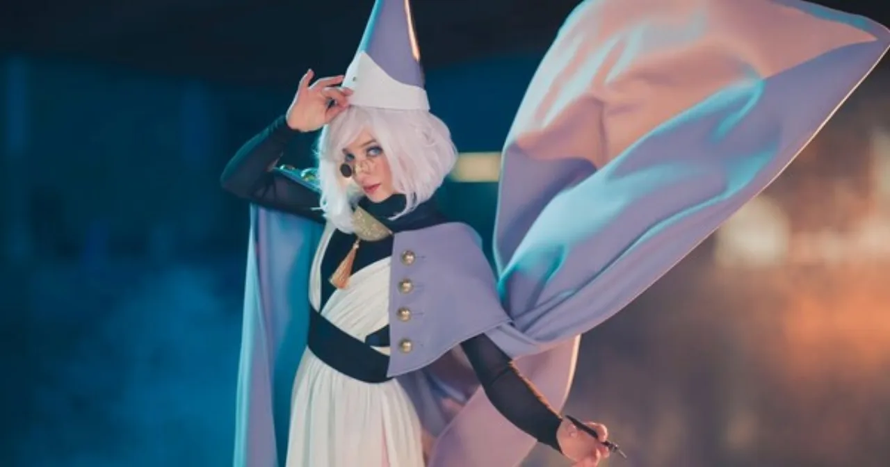 Amber Glenn desliza no gelo usando traje de patinação artística, com luvas brancas e expressão concentrada