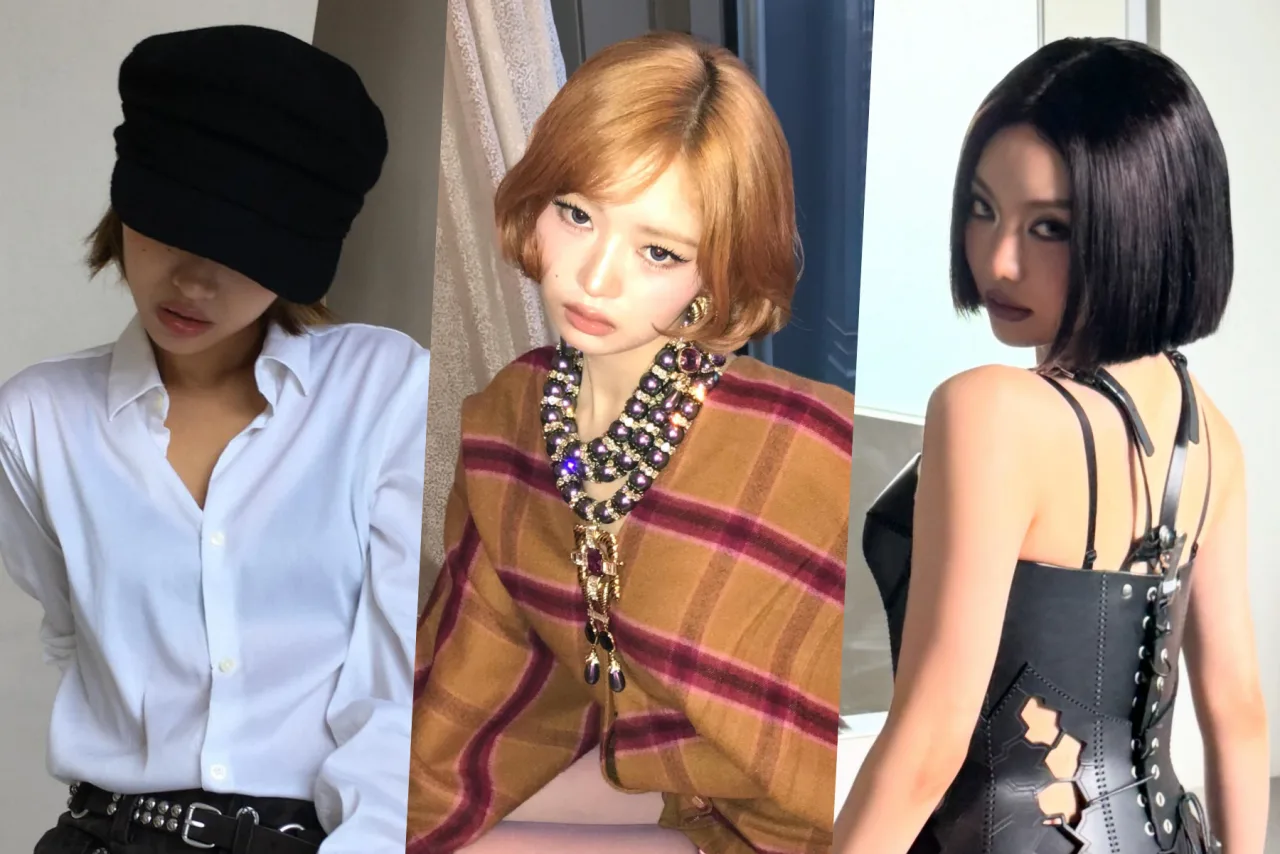 Soyeon, da i‑dle, aparece com corte de cabelo desfiado, jaqueta de couro com spikes e correntes, exalando atitude punk
