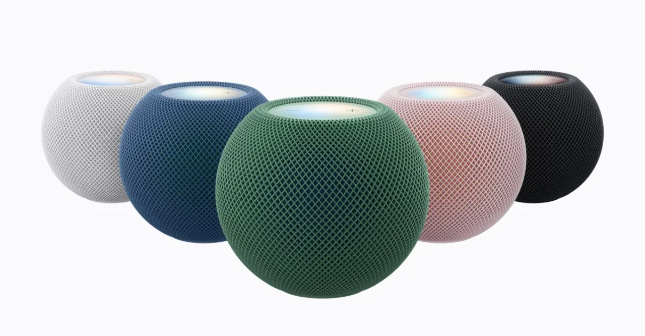 HomePod Mini 2 da Apple com iluminação colorida ao redor, exibindo o logotipo da marca sobre fundo escuro