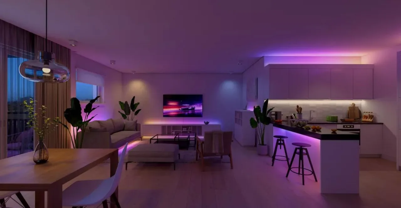 Pessoa praticando yoga em ambiente iluminado por lâmpadas Philips Hue coloridas