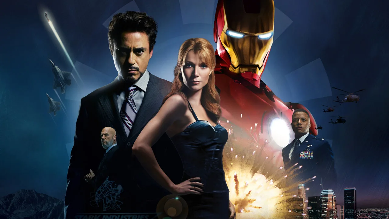 Homem musculoso vestindo camiseta do Iron Man faz agachamento com barra ao lado de um poster do Black Panther