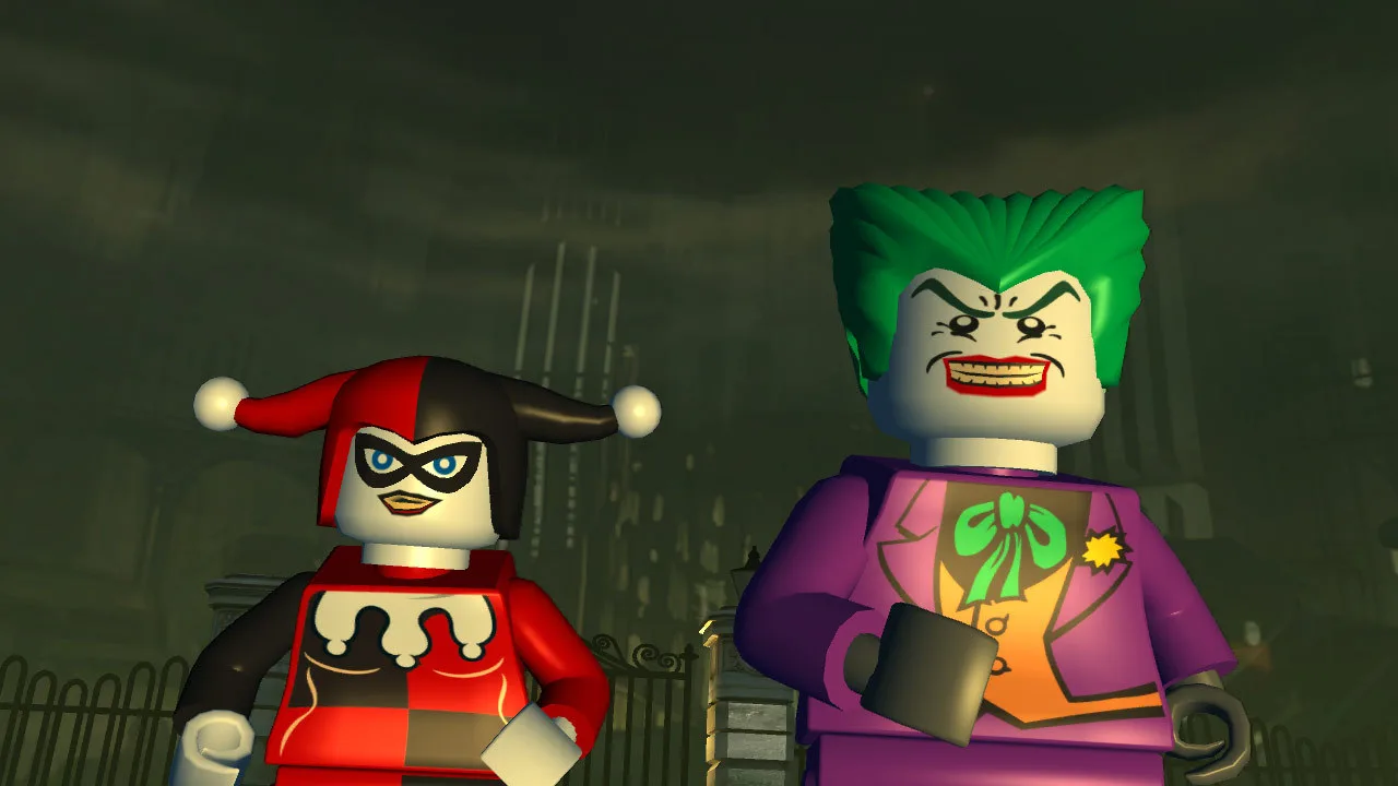 Controle de videogame, console Switch 2 e boneco LEGO do Batman sobre uma mesa com um copo de suco detox ao lado