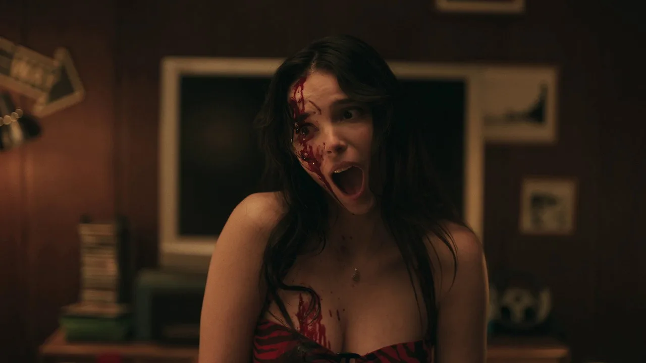 Mulher fazendo agachamento com halteres ao fundo, tela de cinema exibindo cena de Obsession