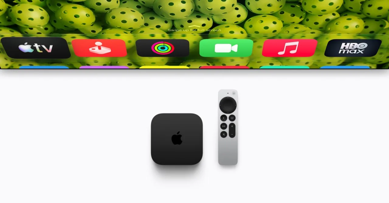 Controle remoto da Apple TV 4K 2024 com microfones embutidos ao lado de uma TV exibindo o ícone da Siri