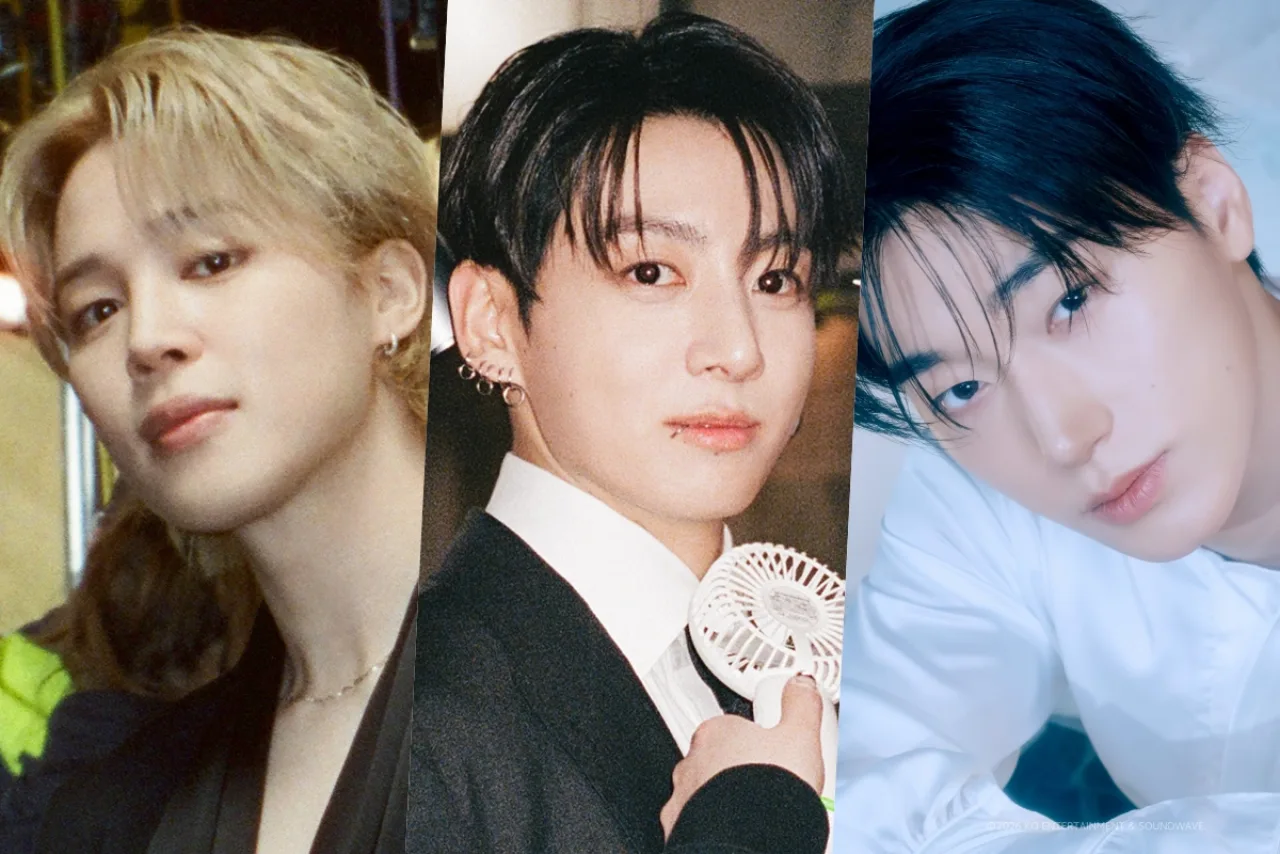 Jimin em roupa esportiva, fazendo flexões no chão de academia, rodeado por halteres e uma garrafa de água