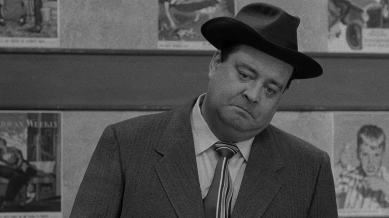 Couch vintage dos anos 50 com controle remoto, pipoca e halteres ao lado, sugerindo maratona de sitcoms