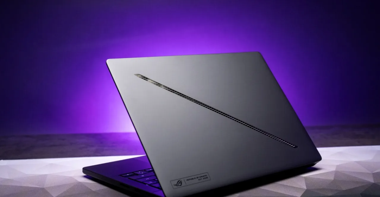 Notebook gamer Asus ROG Zephyrus G14 sobre uma mesa minimalista ao lado de um mouse e um fone de ouvido premium